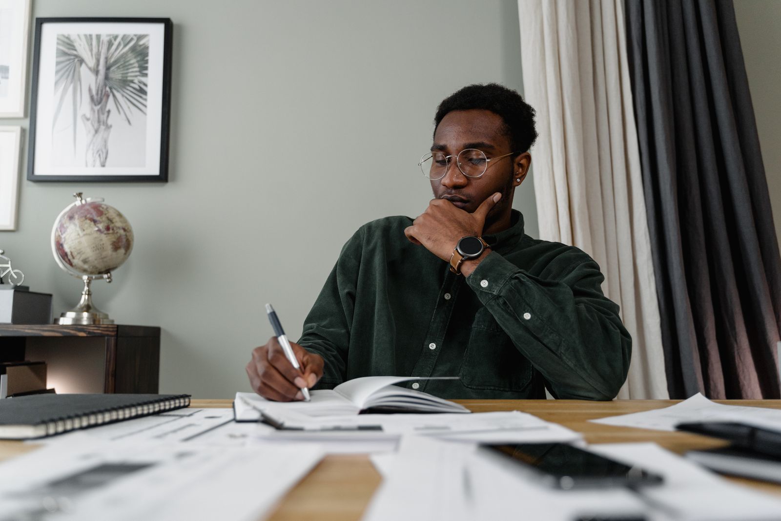 A focused professional reviewing a shortlist at a desk.